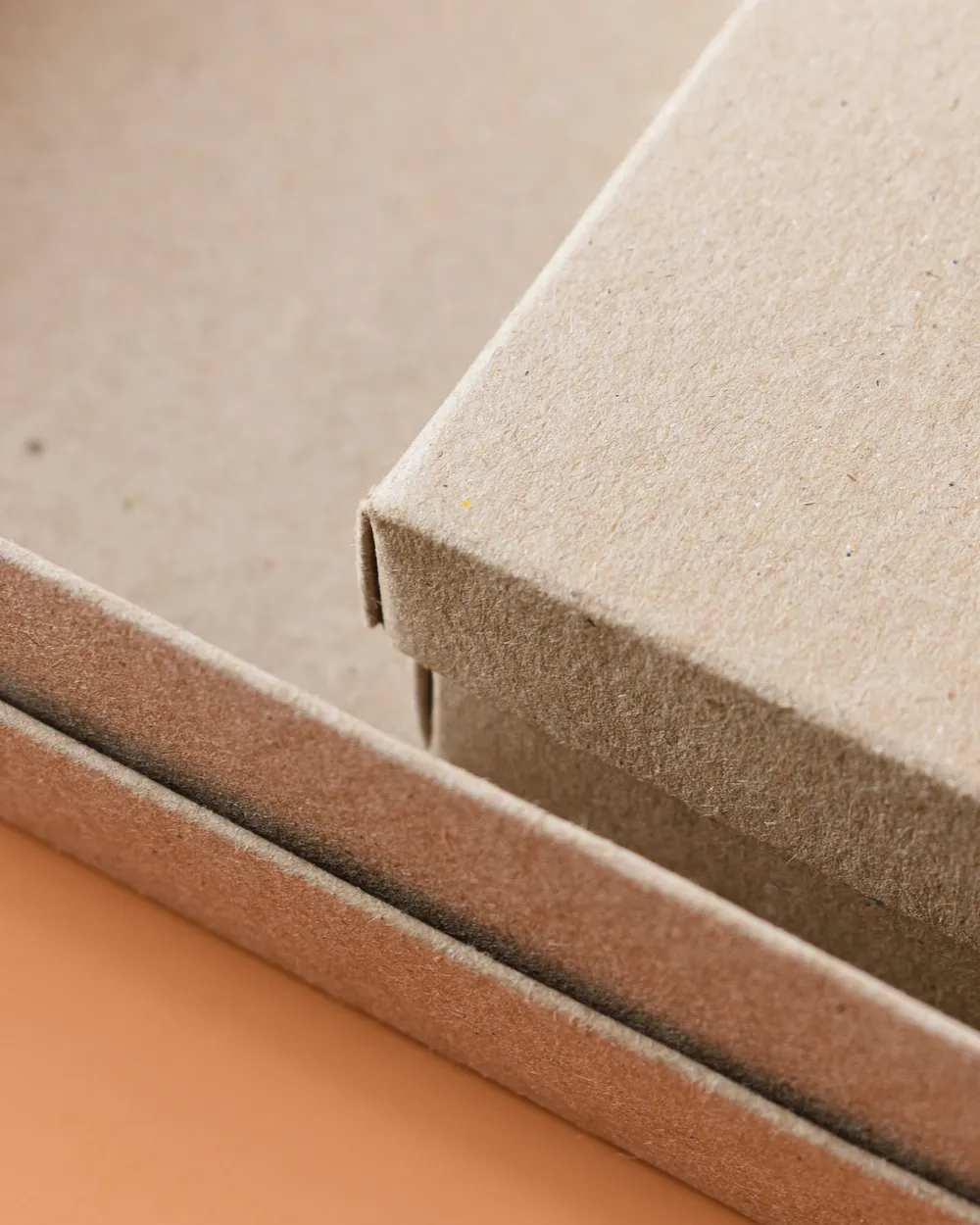Close-up of the corner of a plain boxboard lid resting on its base