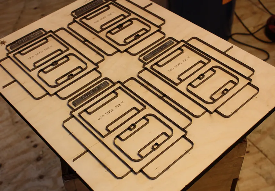 Plywood cutting formes with steel rule bent to the shape of four carton blanks