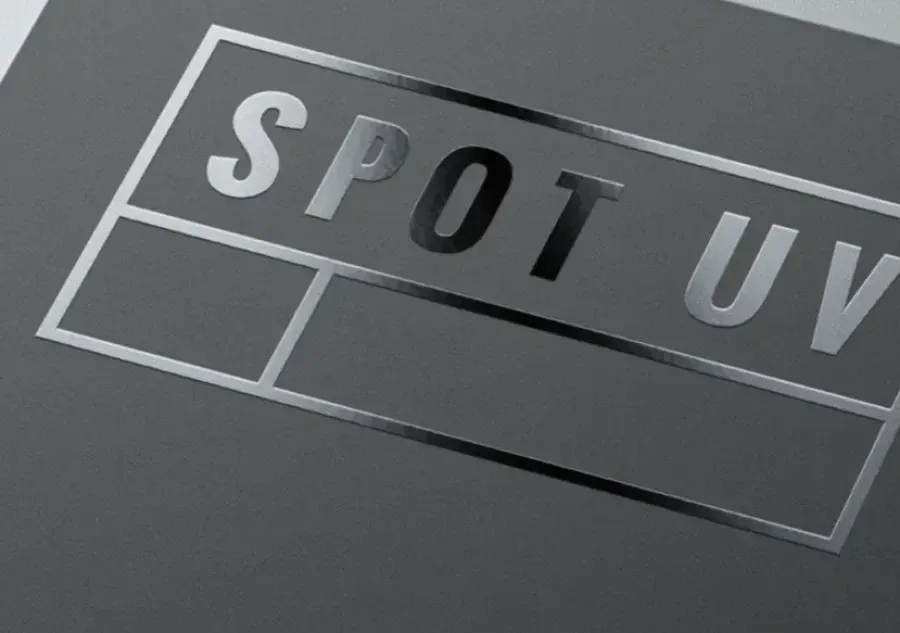 Gloss Spot UV lettering catching the light against a matt grey printed panel